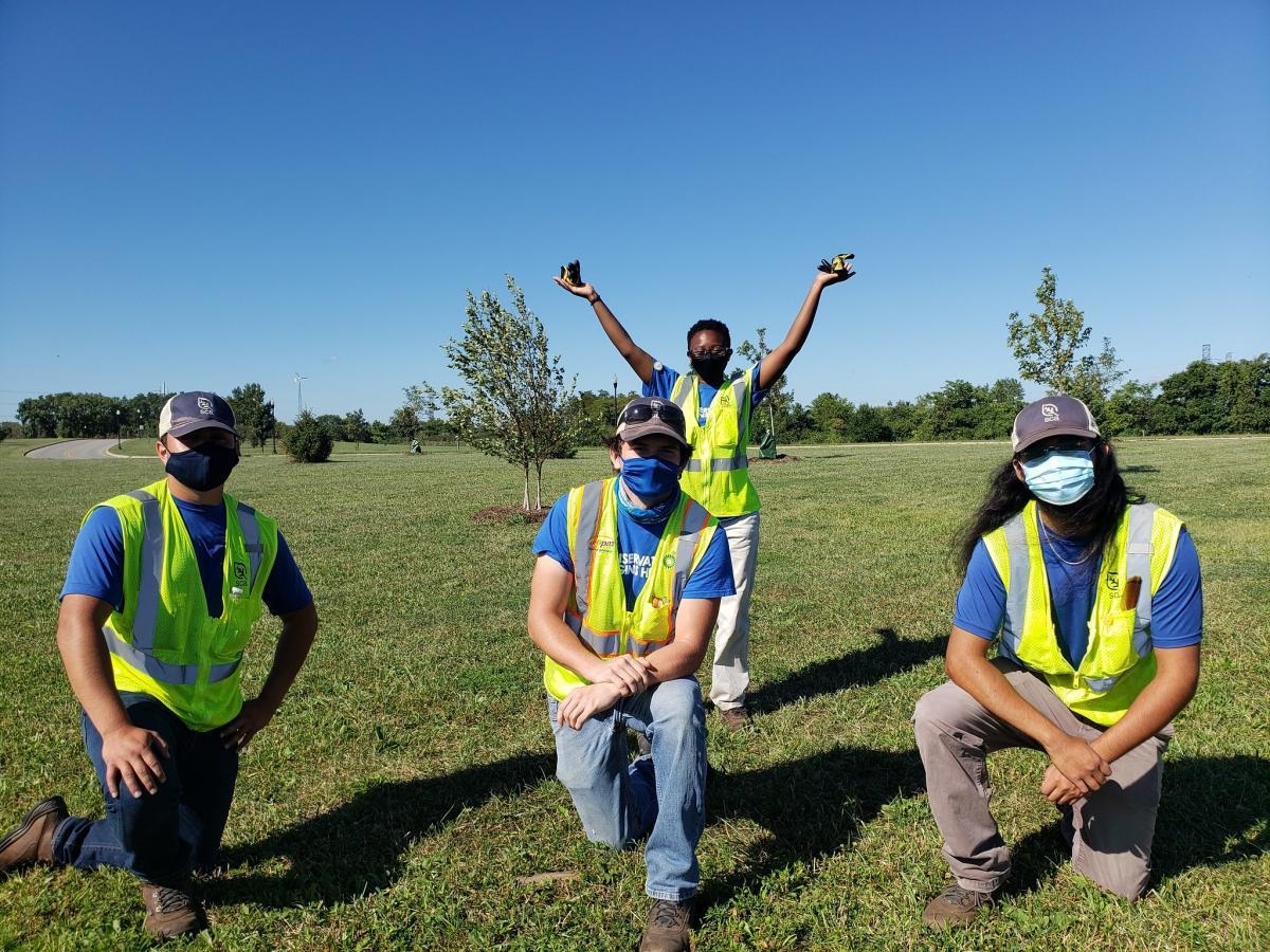 Four SCA members with masks posing outside