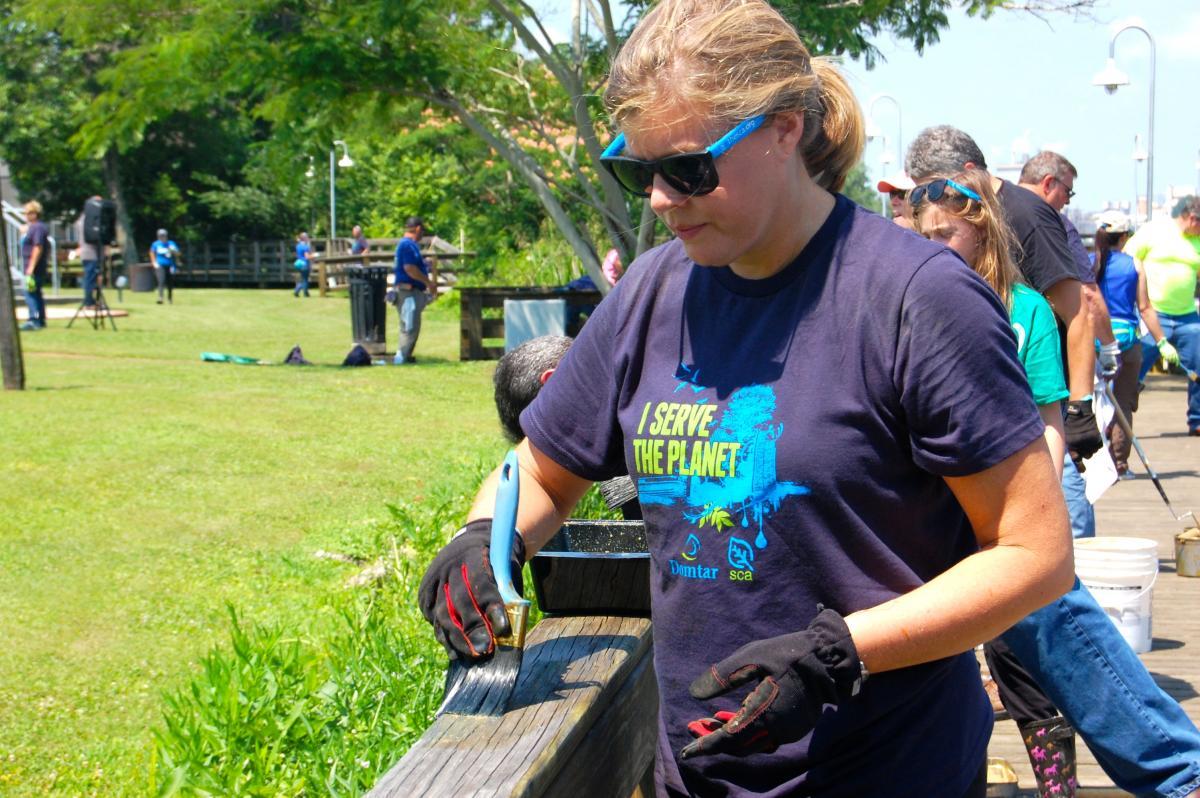 Domtar volunteers paint the boardwalk in historic Plymouth, North Carolina