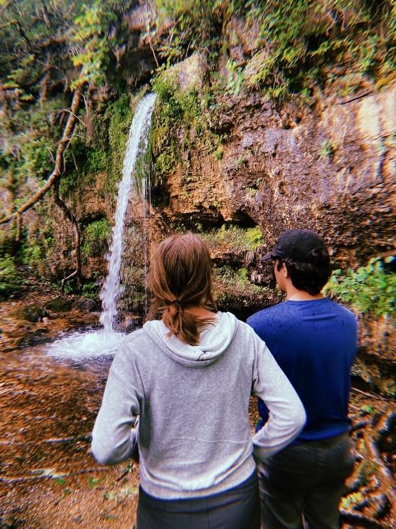 Two people looking at waterfall