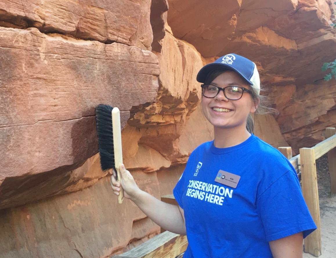 SCA Cultural Resources Intern Kiara Serantes cleans up graffiti in one of Zion National Park's famous slot canyons. 