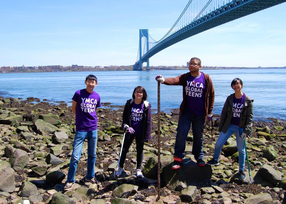 Youth volunteers from YMCA collect trash under the Verrazano Bridge