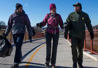 SCA's Roland Richardson walking with US Secretary of the Interior Sally Jewell and an NPS employee